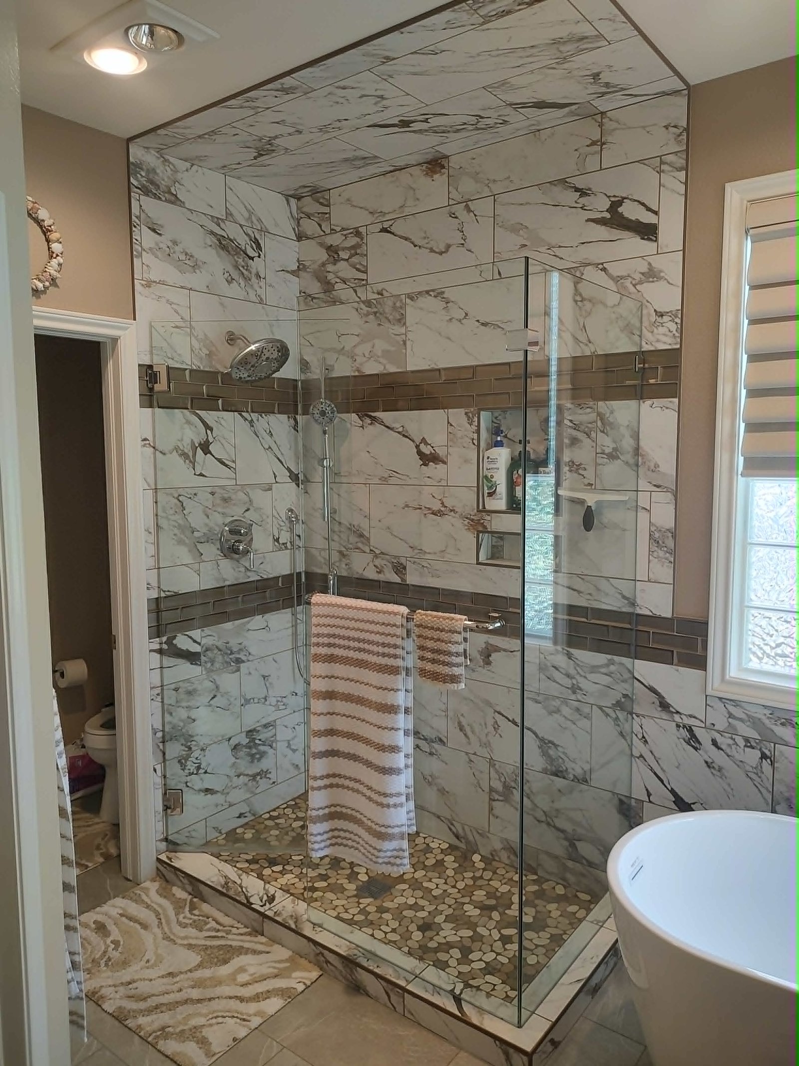 Marble Shower with Brown Accent Bands